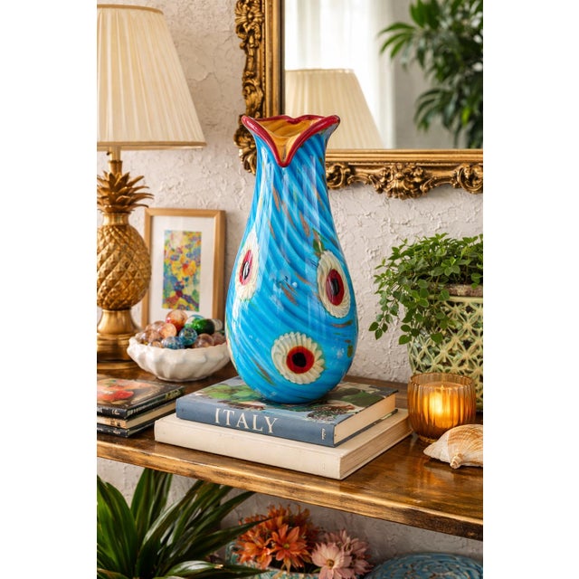 This striking vintage Murano art glass vase showcases exceptional Italian craftsmanship, featuring a vivid turquoise blue...