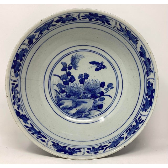 Beautiful 19th C Canton blue and white centerpiece export bowl. Features peonies, birds, and butterflies. Hairline crack...
