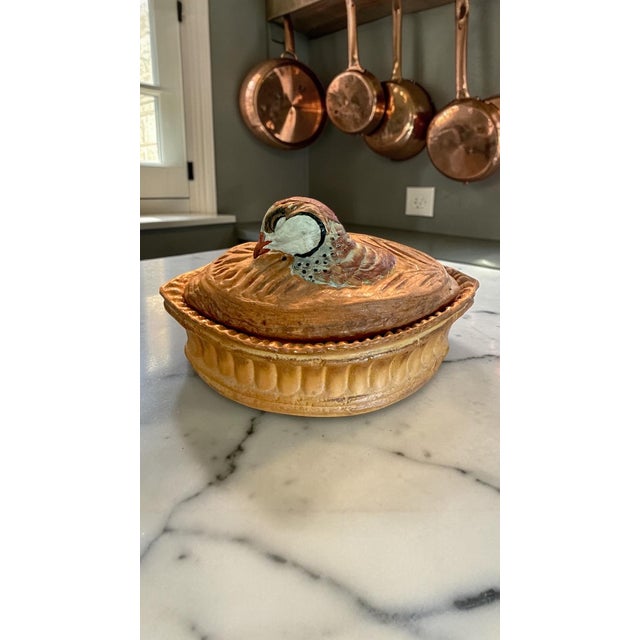 A striking vintage French porcelain terrine by Pullivuyt of Limoges, featuring a sculpted partridge (perdrix) resting...