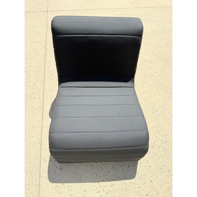 Striking postmodern sculptural chaise lounge in durable black fabric, defined by its bold, continuous S-curve silhouette...