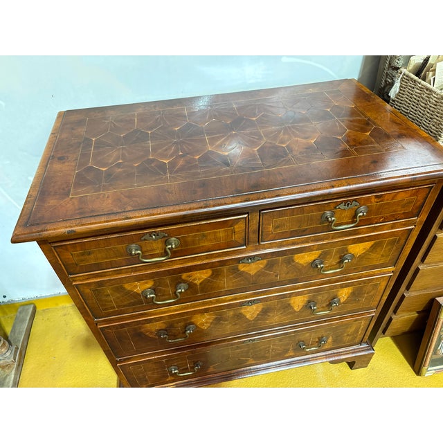 An elegant 19th-century Georgian-style chest of drawers, crafted using end-grain marquetry, featuring remarkable graphic...