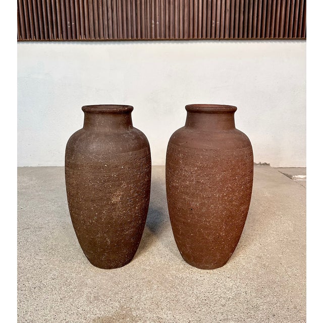 This set of two large amphora-shaped terracotta floor vases was handcrafted by an unknown ceramist in West-Germany around...