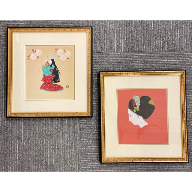 A Pair of Finely Framed Japanese Woodblocks. Each of a Geisha in dress the pair both having artist signature in Japanese....
