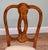 Elegant pair of side chairs with shaped open backs and intricate floral marquetry decoration. The curved back frames...