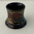 A charming miniature example of early 20th-century Dutch art pottery, this antique Gouda Holland vase features richly...