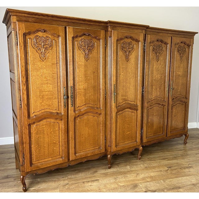 A striking Vintage French Louis wardrobe, beautifully crafted with ornate carved detailing and a rich oak finish that...