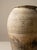 Spanish terracotta jar with a striated finish and natural patina in beige and brown tones. The surface displays chromatic...