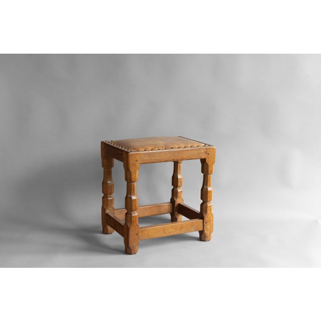 Oak framed stool with original leather top. Circa 1950.