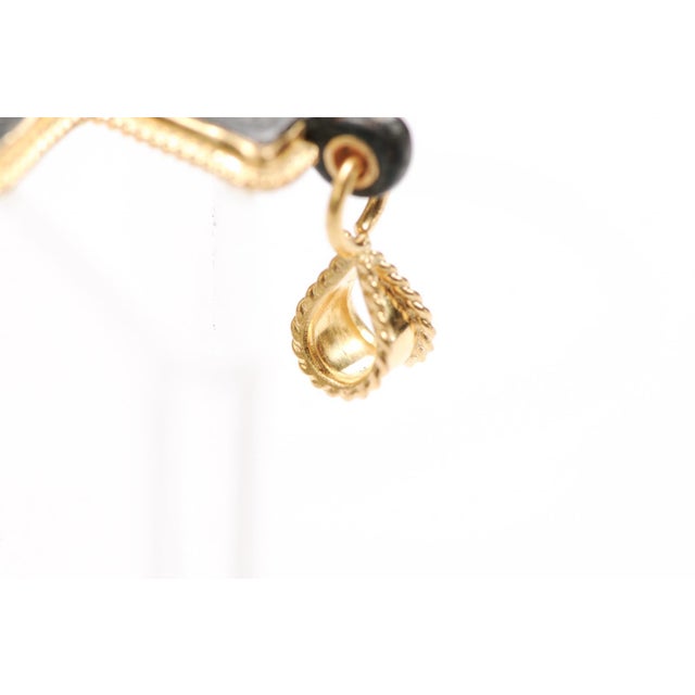 A very thin Bronze Byzantine Cross from the IV to VI Centuries AD trimmed with a delicate rope motif in 21 karat gold....