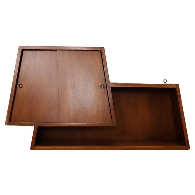 Amazing design in mahogany wood and brass accents, circa 1950.