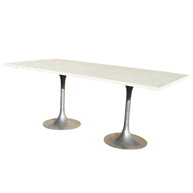 This striking Mid-Century Modern dining table is designed in the iconic style of Eero Saarinen’s Tulip Collection,...
