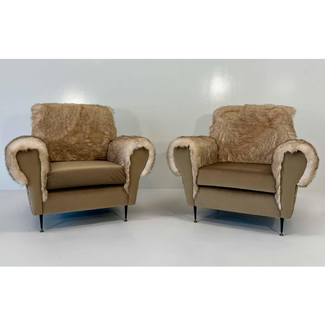 Elegant and highly distinctive pair of Italian armchairs dating from the 1950s, distinguished by their generous...