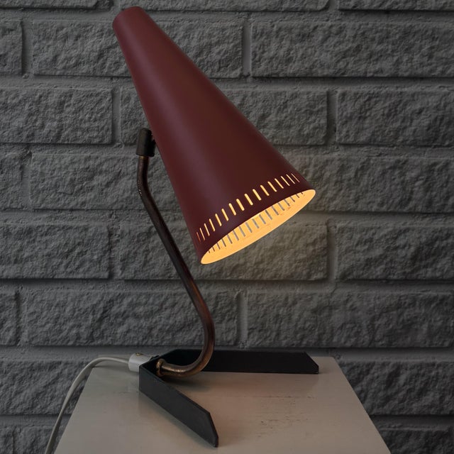 A distinctive swedish table lamp manufactured by gnosjö konstsmide in the 1950s, combining sculptural form with the...