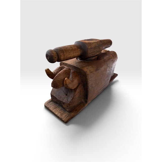 An exceptional antique hand-carved wooden mortar and pestle featuring a substantial solid hardwood body with a deep...
