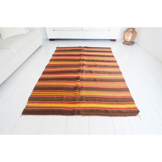 This is a vintage Turkish Oushak rug from the Mid 20th Century. The piece was hand-knotted.