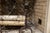 A pair of antique wrought iron andirons (fireplace log holders) with tall spiral-twist shafts with scrolled finials,...