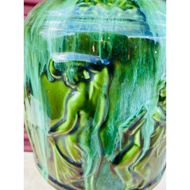 This is a vintage majolica American made classical vase. This vase has classical Figural forms around the entire surface...