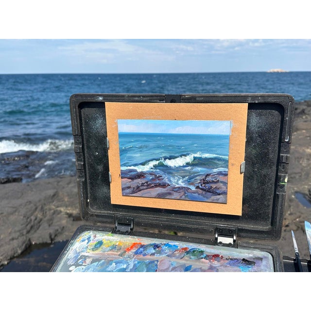 This oil painting captures the dynamic interplay between land and sea, depicting waves crashing against rocky shores under...