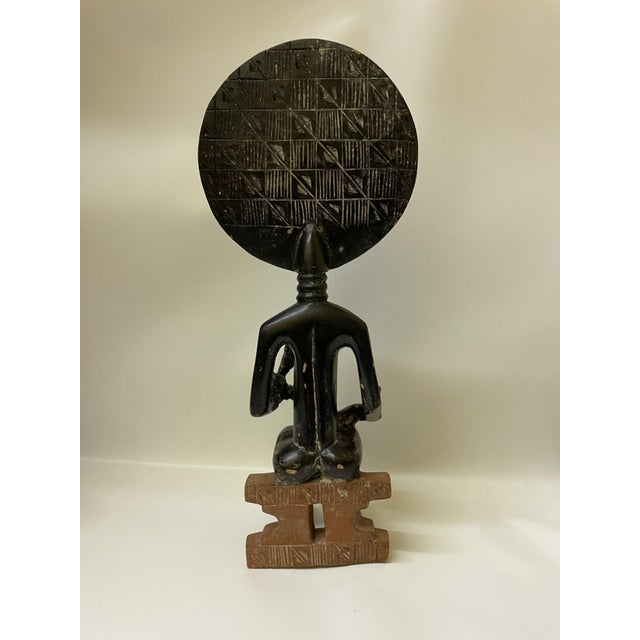 Bring a powerful piece of West African heritage and artistry into your space with this striking, vintage mid-20th-century...