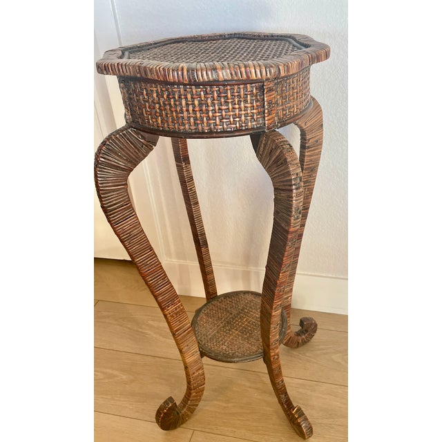 Graceful, rattan-wrapped wooden plant stand with 4 curved legs plus lower shelf, visually pleasing in all aspects....