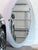 A large landscape-oriented oval wall mirror with a sleek dark matte frame. Clean, versatile design suits a variety of...