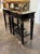 This product is a pair of antique black lacquered Jansen Manner side tables with brass details. These side tables are...