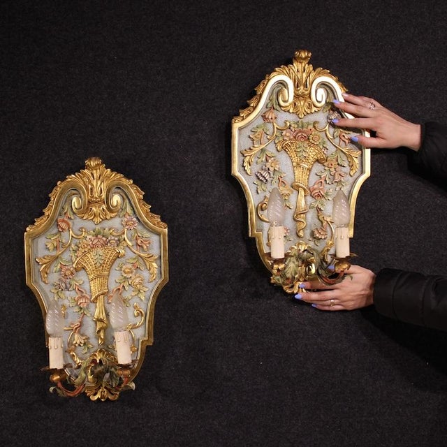 A pair of Italian wall lamps from the 1960s. Finely crafted, lacquered, and gilded antique Louis XVI-style furniture of...