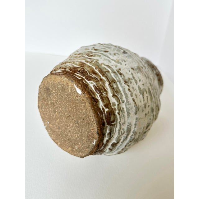 This one-of-a-kind hand-thrown ceramic vase celebrates the beauty of imperfection with its richly textured surface and...