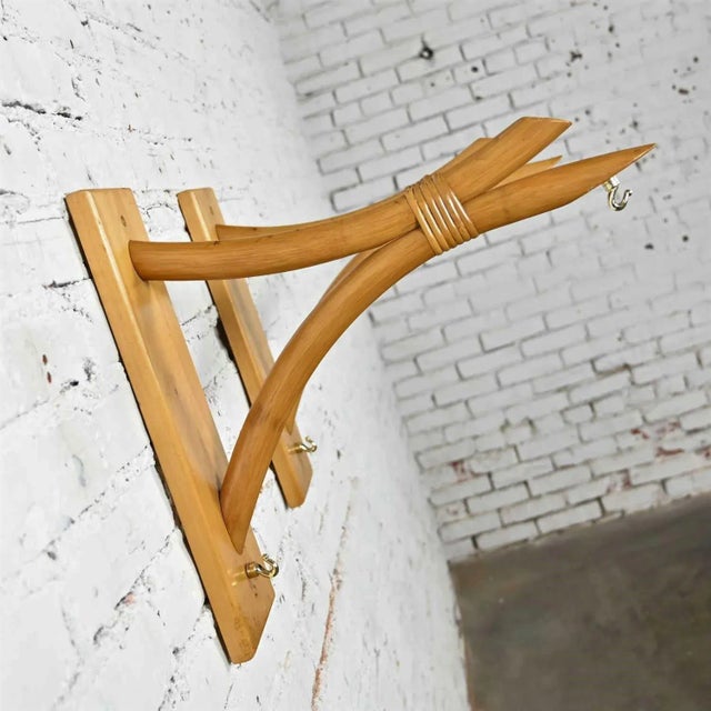 Awesome pair of mid-century modern rattan wall brackets with wood mounts and brass plated hooks. Wonderful condition,...