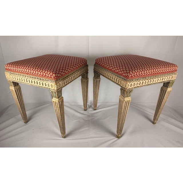 A very elegant and decorative pair of mid-20th century French Louis XVI style painted stools. These exquisite vintage...