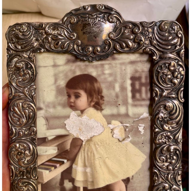 This is a sweet Victorian period sterling silver frame with a pleasing repeating embossed pattern of swirls with stylized...