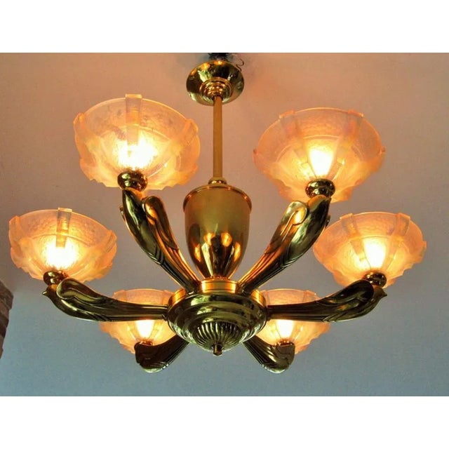 This Art Deco chandelier features 24-carat gold plating and opalized glass shades. This piece is attributed to the...