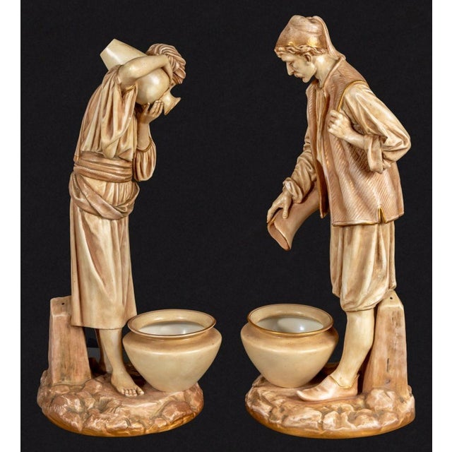 Pair of Royal Worcester "Water Carriers" Porcelain Figures, modeled by James Hadley, circa 1890, a male and female figure...