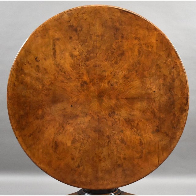 Regency Quarter-Veneered Burr Elm Tilt-Top Centre Table A striking early 19th-century Regency centre table, featuring a...