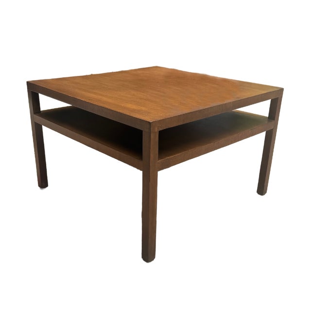 This is a mid century modern Widdicomb square cocktail table in warm walnut featuring clean architectural lines and an...