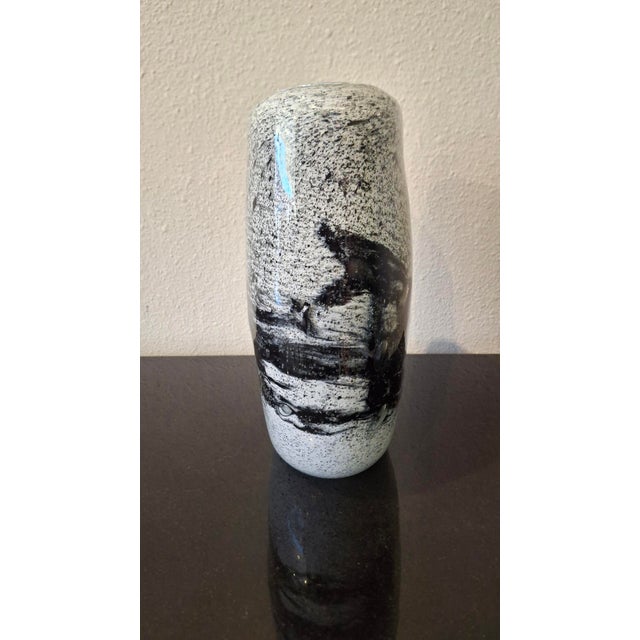 The Spilled Black series is made of recycled glass by Belgian glass artist Henry Dean. The white core of the vase is shot...