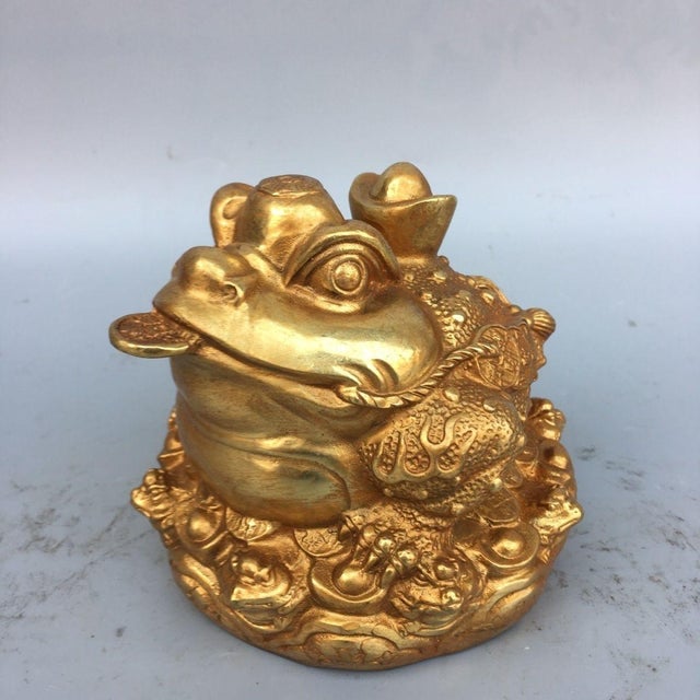 This is a substantial and highly detailed gilt bronze sculpture of a mythical three-legged toad, a traditional symbol of...
