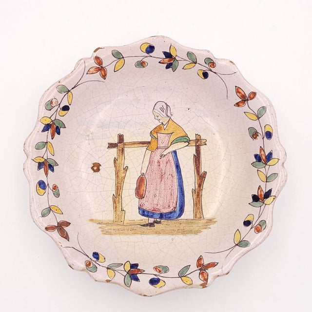 A pair of Quimper plates, France, 19th century. "P.B." mark on reverse.