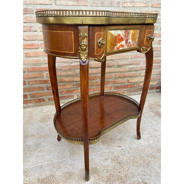 Pair of kidney-shaped Transition style nightstands in carved wood with gilt bronze appliqués and gallery. Two heights and...