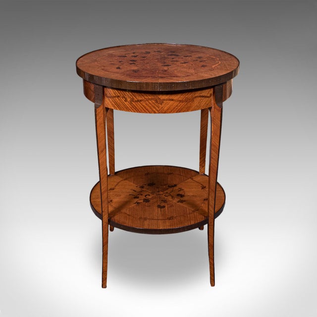 This is an antique two tier occasional table. A French, Kingwood and marquetry lamp table or jardiniere stand, dating to...