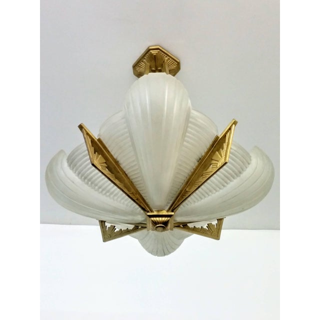 A French Art Deco pendant chandelier by the French artist " Atelier Petitot " in excellent condition. Shades are in clear...