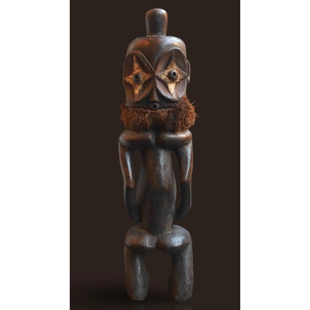 This item is an African tribal art figure, likely from the Songye people of the Yaka people, used as an ancestral or...