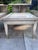 A matched pair of mid-century step end tables by Lane Furniture of Altavista, Virginia. Their pale, bleached, glossy...