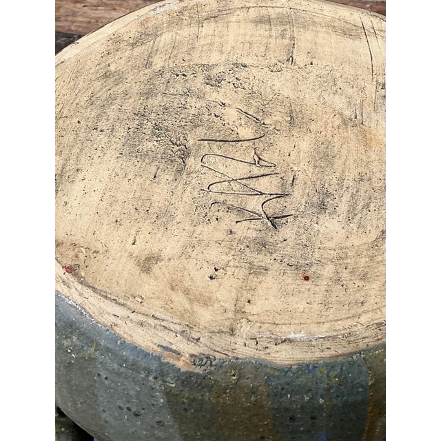 This striking vintage studio pottery serving platter is a masterclass in organic modernism and tactile craftsmanship....