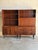 This impressive modular modular storage system presents a dual-bay layout combining open bookcases over functional base...