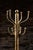 This antique brass 12-hook coat rack likely originated in the 1940s.