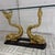 This extraordinary pair of tables features two large brass coy carp on each base with their tails rising up to form a...