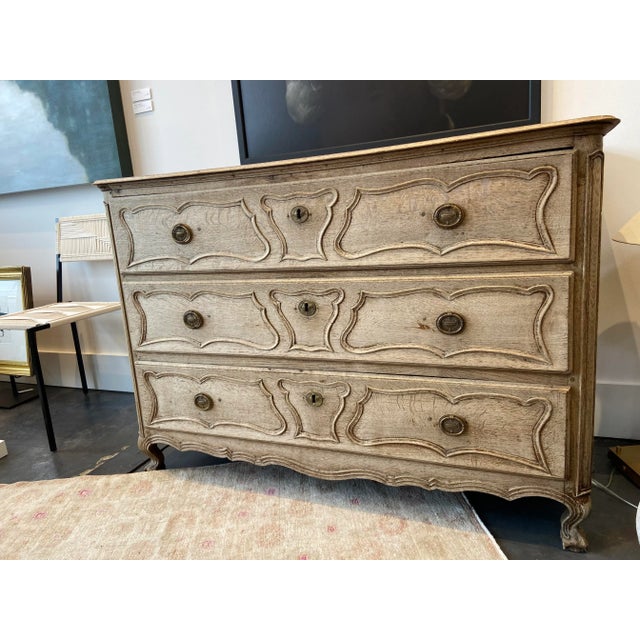 1800s Antique French Bleached Commode with beautiful detailing! The piece features two front cabriole legs, detailed...