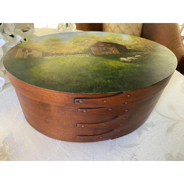1980's Oval Bentwood Shaker Box, Folk Art Rural Scene, Artist Signed INEZ, 11" Eagle Bay Heirlooms is pleased to offer...
