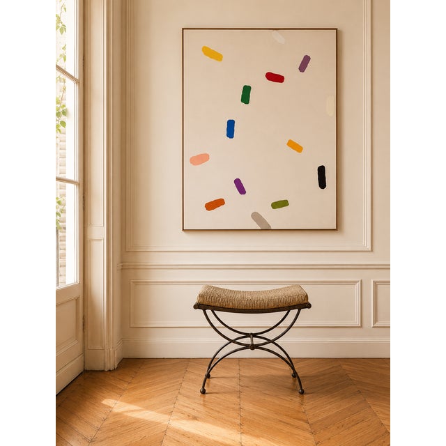 Curule stool in patinated iron and seat in bronze fabric from Maison Nobilis, with an airy and timeless design